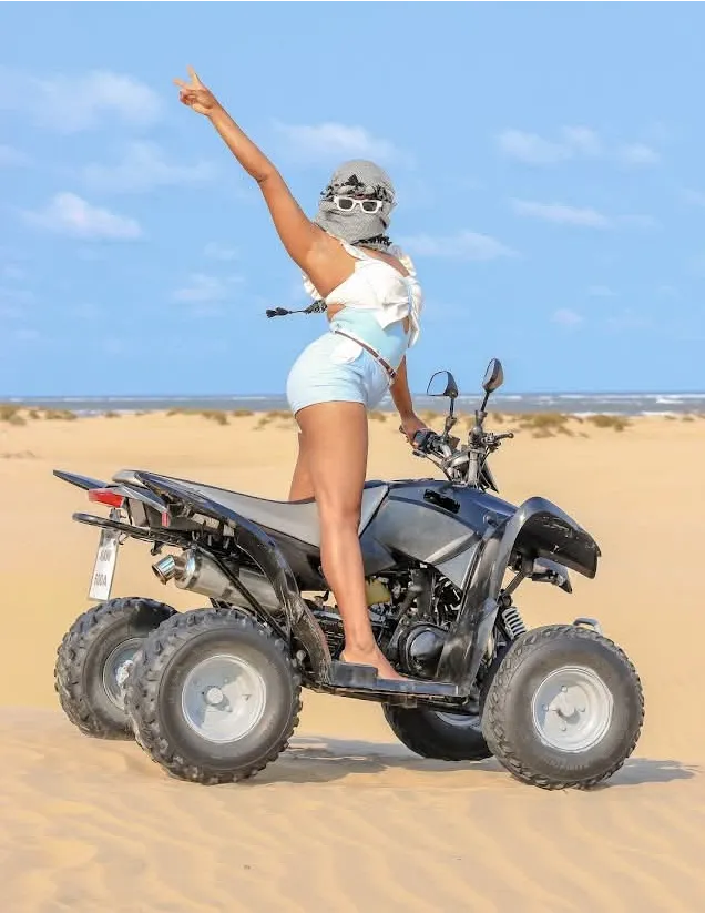 Guest riding a quad bike on a sandy Dubai Beach stop during a Mombasa tours excursion