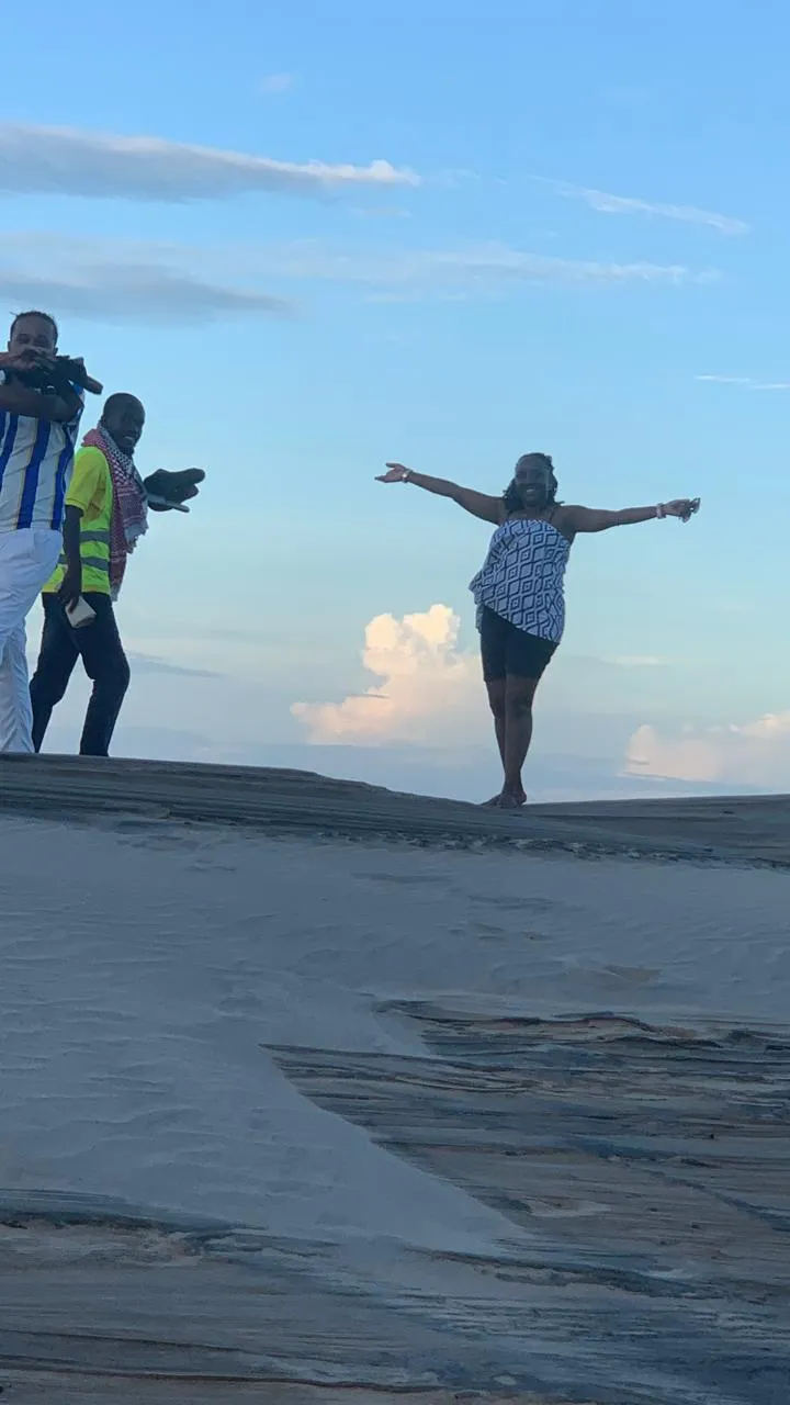 Guests posing on the dunes for sunset photos during a Mombasa tours sandbank stop